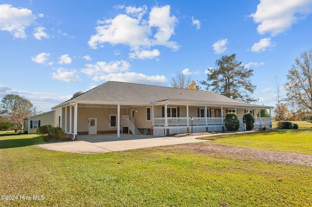 rear view of house featuring a porch and a yard