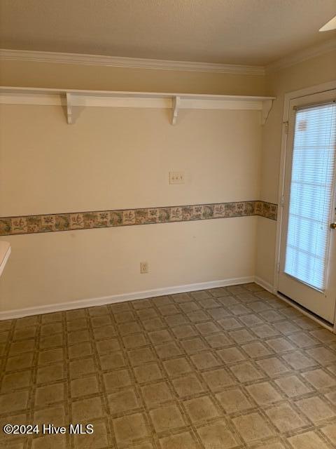 unfurnished room with crown molding