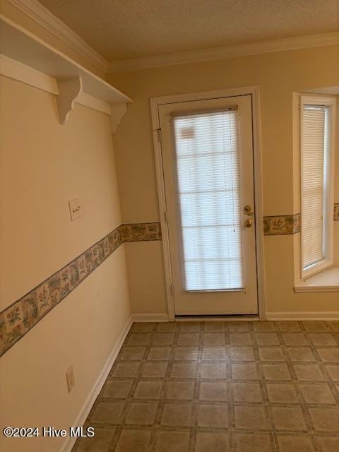 doorway to outside with crown molding and a textured ceiling