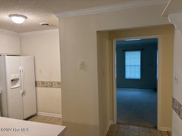 bathroom featuring ornamental molding and a textured ceiling