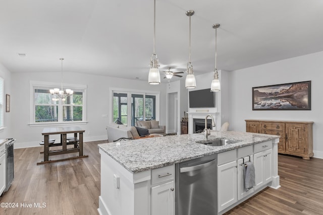 kitchen with dishwasher, sink, a center island with sink, white cabinets, and ceiling fan with notable chandelier