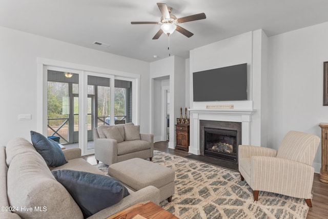 living room with ceiling fan and wood-type flooring