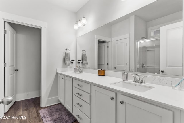 bathroom featuring vanity, an enclosed shower, and hardwood / wood-style flooring