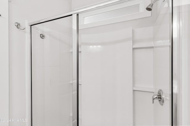 bathroom with a shower with shower door