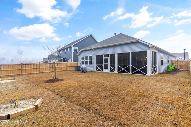 rear view of house with a sunroom and cooling unit