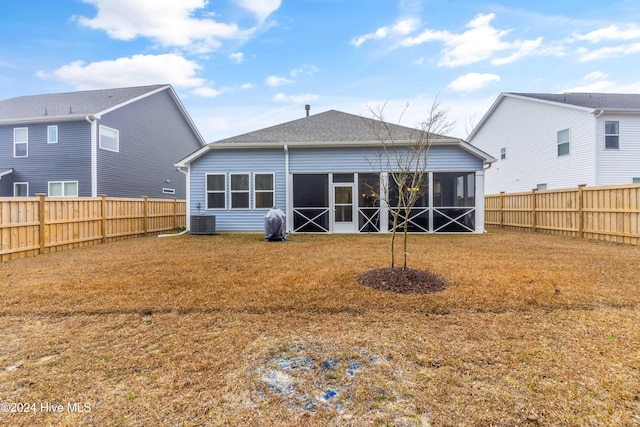 rear view of property featuring a sunroom and cooling unit