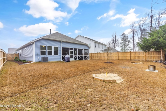 rear view of property featuring a sunroom and cooling unit