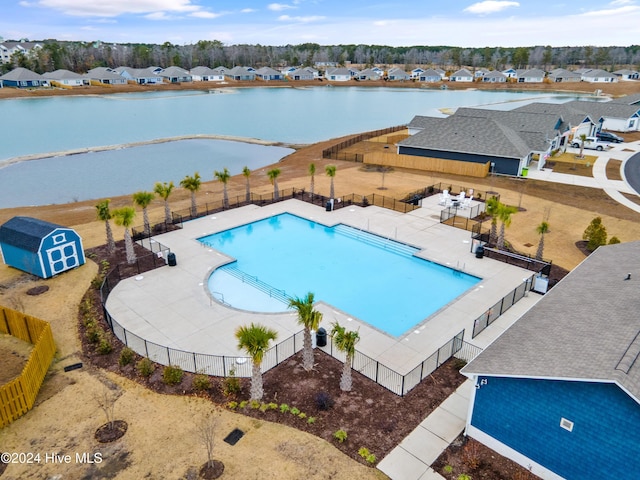 view of swimming pool with a water view