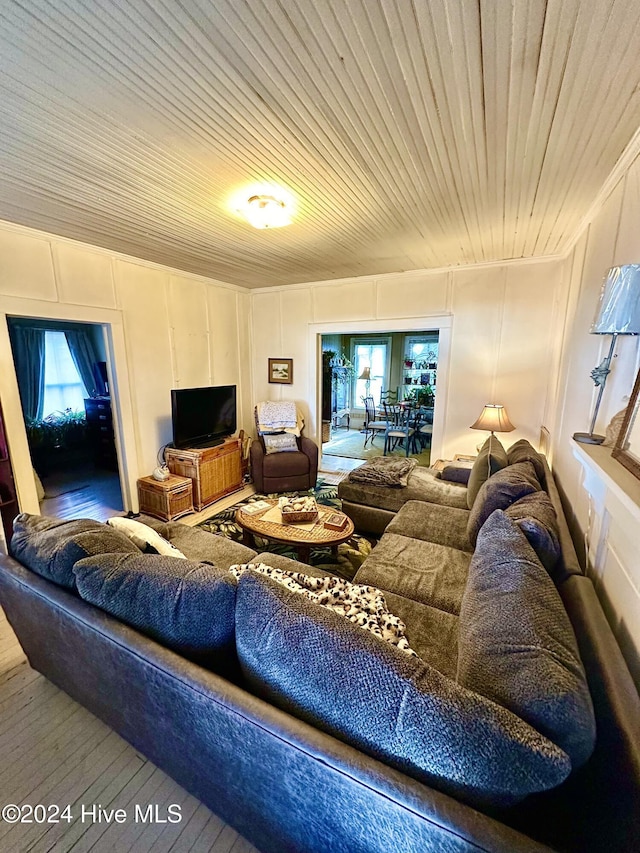 living room featuring hardwood / wood-style flooring and wood ceiling