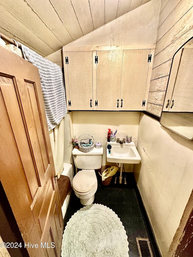 bathroom with sink, wood walls, lofted ceiling, toilet, and wood ceiling