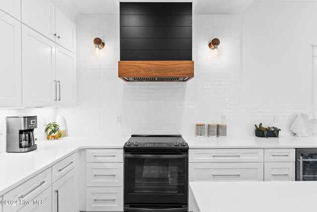 kitchen featuring wine cooler, white cabinetry, black / electric stove, and backsplash