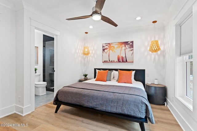 bedroom with hardwood / wood-style floors, ceiling fan, ornamental molding, and ensuite bathroom