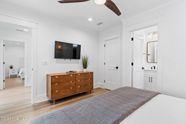 bedroom with wood-type flooring, ensuite bath, and ceiling fan