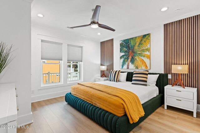 bedroom with light hardwood / wood-style floors and ceiling fan