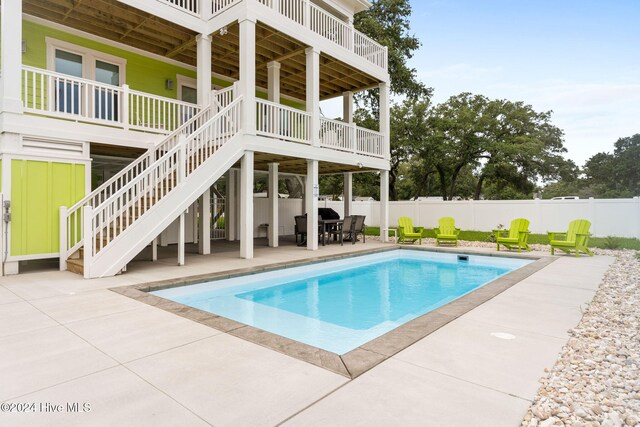 view of swimming pool featuring a patio area