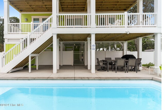 view of pool featuring a patio area and a deck