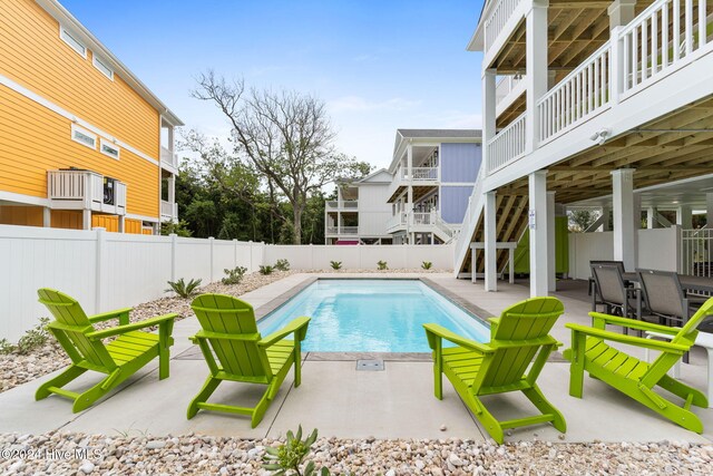 view of pool with a patio and a wooden deck