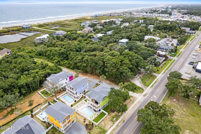 drone / aerial view with a water view and a beach view