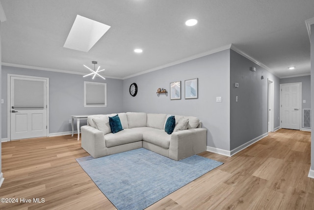 living room featuring a chandelier, a skylight, light hardwood / wood-style flooring, and crown molding