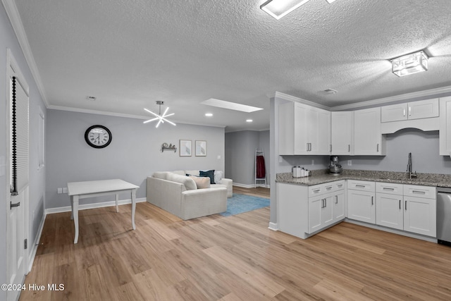 kitchen featuring white cabinetry, crown molding, stainless steel dishwasher, and a textured ceiling