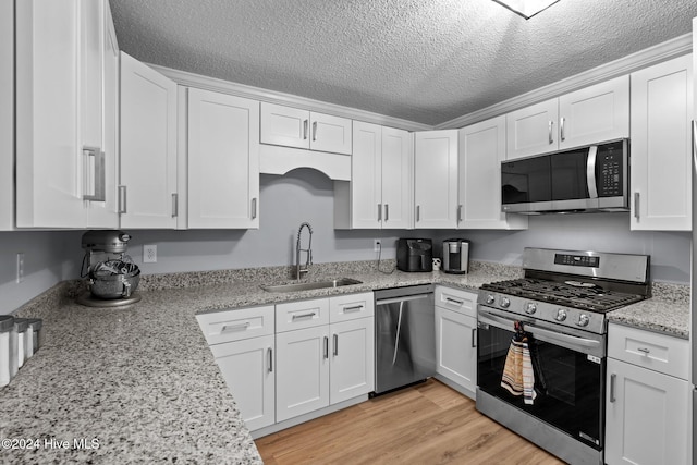 kitchen with white cabinets, sink, and stainless steel appliances