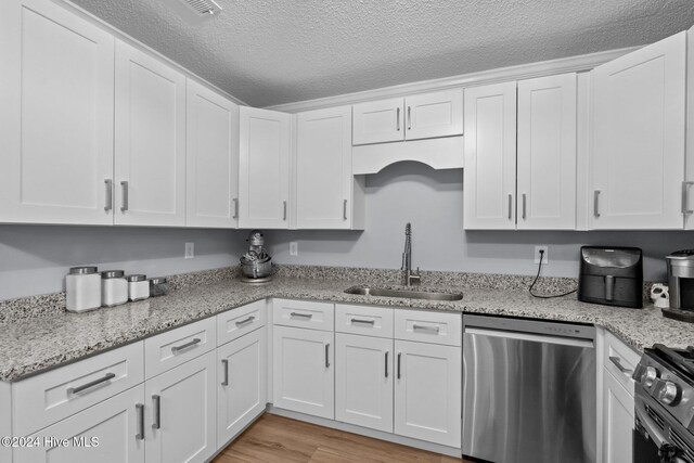 kitchen featuring dishwasher, white cabinetry, black range with electric stovetop, and sink