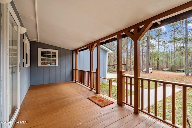 unfurnished sunroom featuring vaulted ceiling