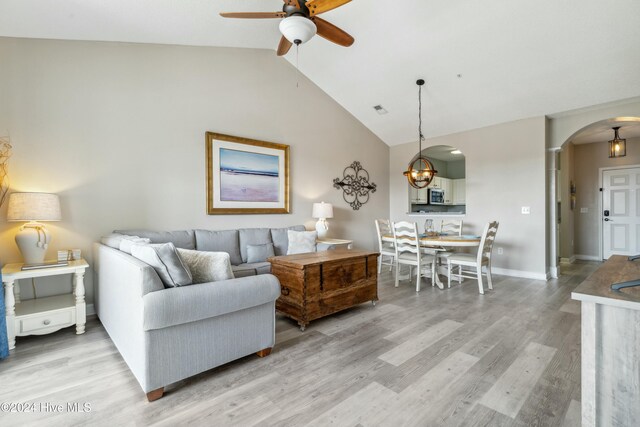 living room with ceiling fan, vaulted ceiling, and hardwood / wood-style flooring