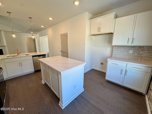 kitchen with a sink, dark wood-style floors, white cabinetry, and dishwasher