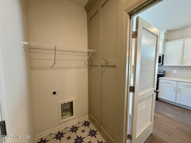 laundry area with laundry area, hookup for an electric dryer, and light floors