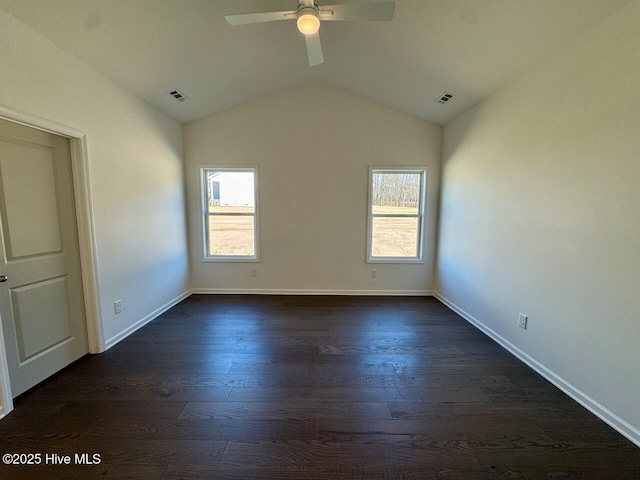 unfurnished room with a healthy amount of sunlight, visible vents, and dark wood finished floors