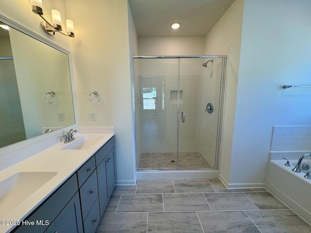 bathroom featuring double vanity, a stall shower, a sink, and a bath