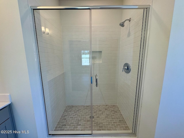 bathroom with a shower stall and vanity