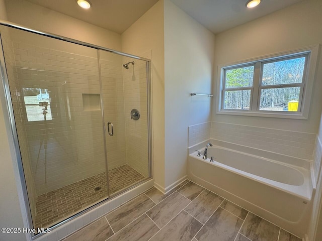 full bath with a garden tub, a shower stall, baseboards, and recessed lighting