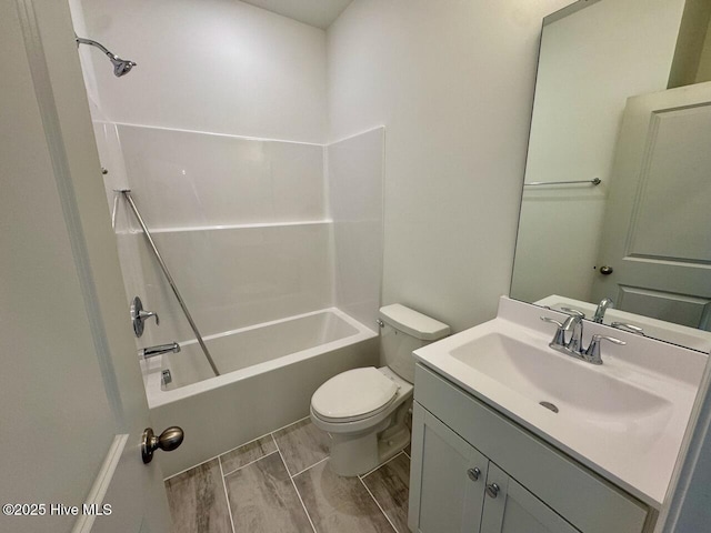 full bathroom with  shower combination, wood tiled floor, vanity, and toilet