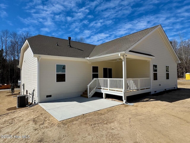 back of house with central AC unit, a patio, roof with shingles, crawl space, and covered porch