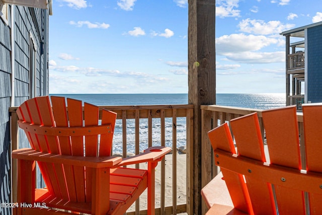 deck with a water view and a beach view