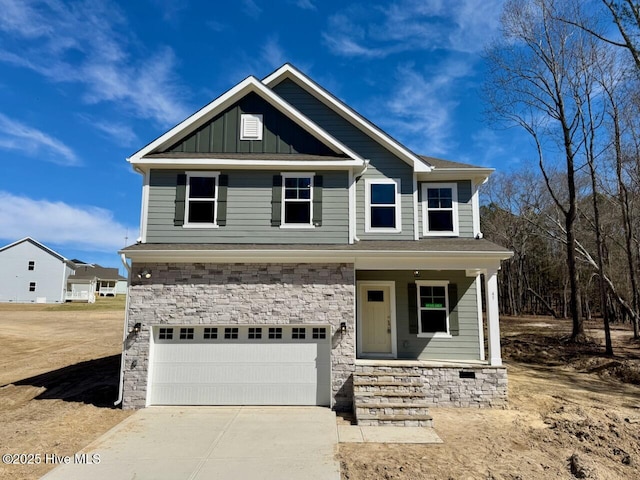 craftsman-style home featuring concrete driveway, stone siding, an attached garage, a porch, and board and batten siding