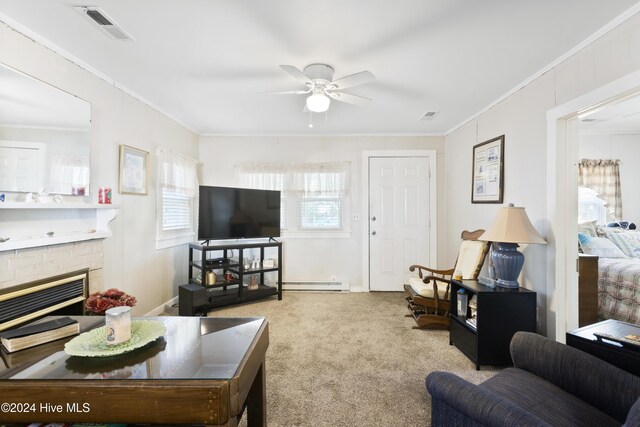 carpeted living room featuring baseboard heating, a brick fireplace, ceiling fan, and ornamental molding