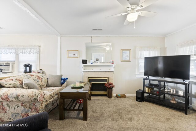 living room featuring plenty of natural light, carpet floors, ornamental molding, and a brick fireplace