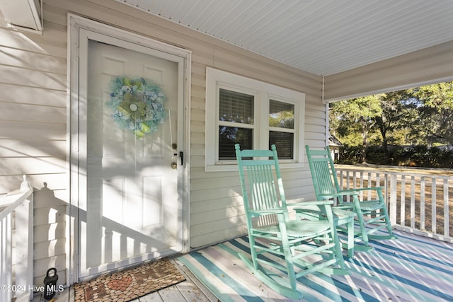 view of exterior entry with covered porch