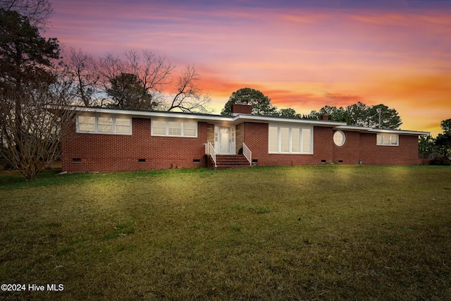 single story home featuring a yard