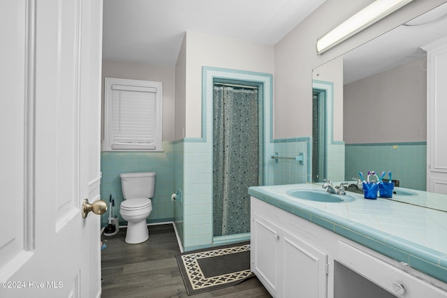 bathroom featuring a shower with shower curtain, tile walls, and hardwood / wood-style flooring