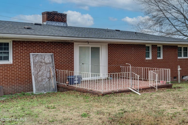 back of property featuring a yard