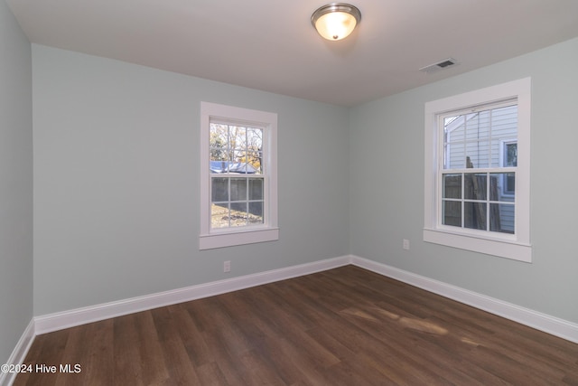 empty room featuring dark hardwood / wood-style flooring