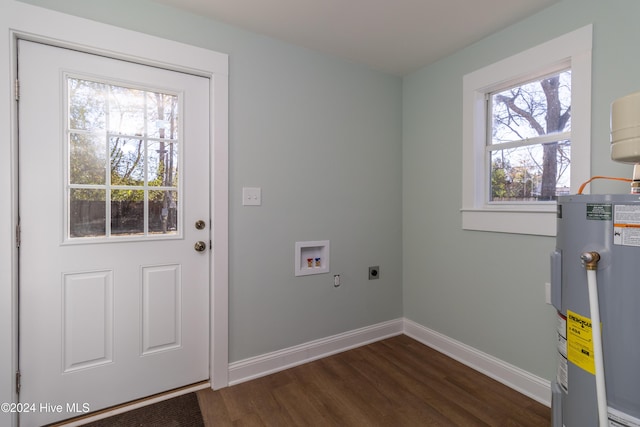 washroom featuring a wealth of natural light, electric water heater, dark wood-type flooring, and hookup for an electric dryer