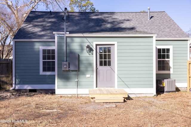 rear view of property featuring cooling unit