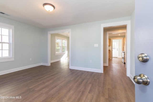 spare room featuring dark hardwood / wood-style flooring