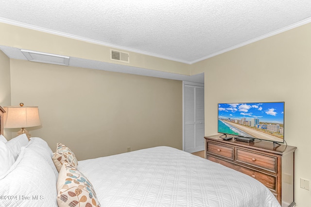 bedroom with a textured ceiling and crown molding