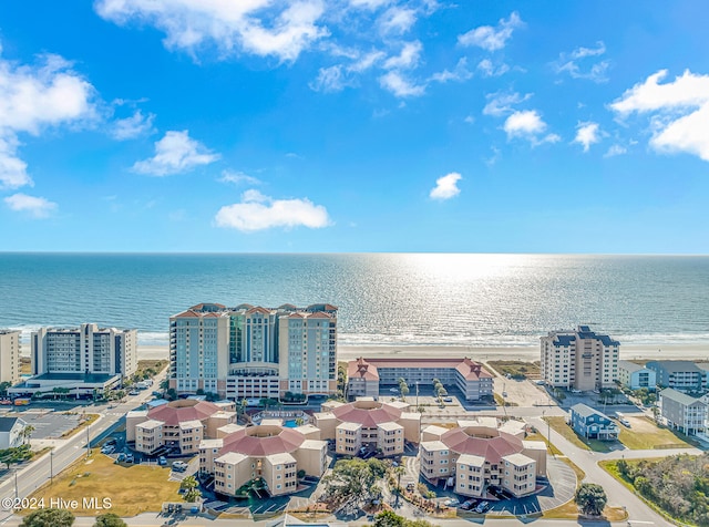 birds eye view of property featuring a beach view and a water view